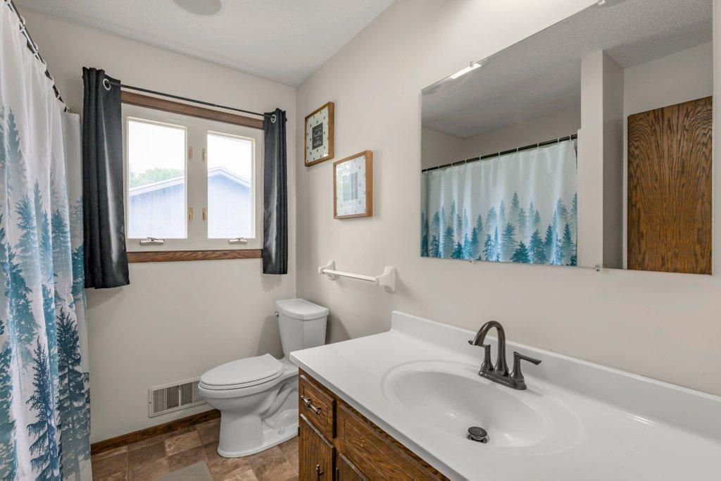 Well-maintained full bathroom featuring an oversized vanity, updated fixtures, natural light, and a functional layout that makes busy mornings easier.