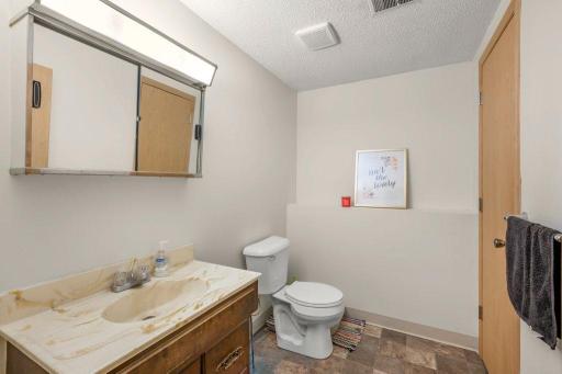 Convenient lower-level Â¾ bathroom with spacious vanity and easy access from the family room and bedrooms, ideal for busy households or overnight guests.