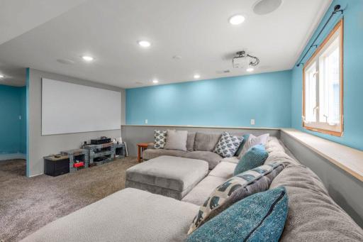 Movie lovers will appreciate this impressive entertainment space featuring a projector setup, oversized gathering area, and endless possibilities for hosting friends and family.