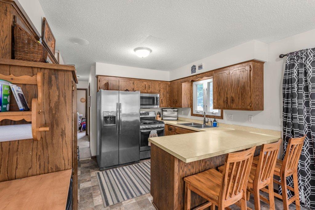 Open-concept kitchen and dining area with abundant cabinetry, breakfast bar seating, generous counter space, and easy access to the dining room, making entertaining a breeze