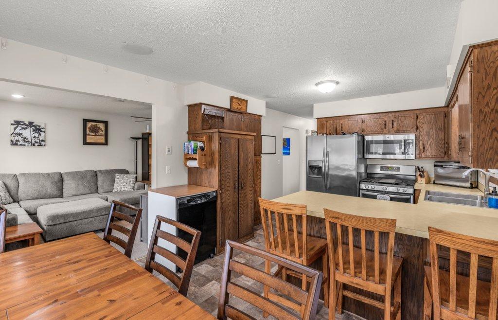 Spacious kitchen with excellent storage, abundant counter space, stainless steel appliances, and a layout that flows seamlessly into the dining and living areas, ideal for everyday living and gatherings.