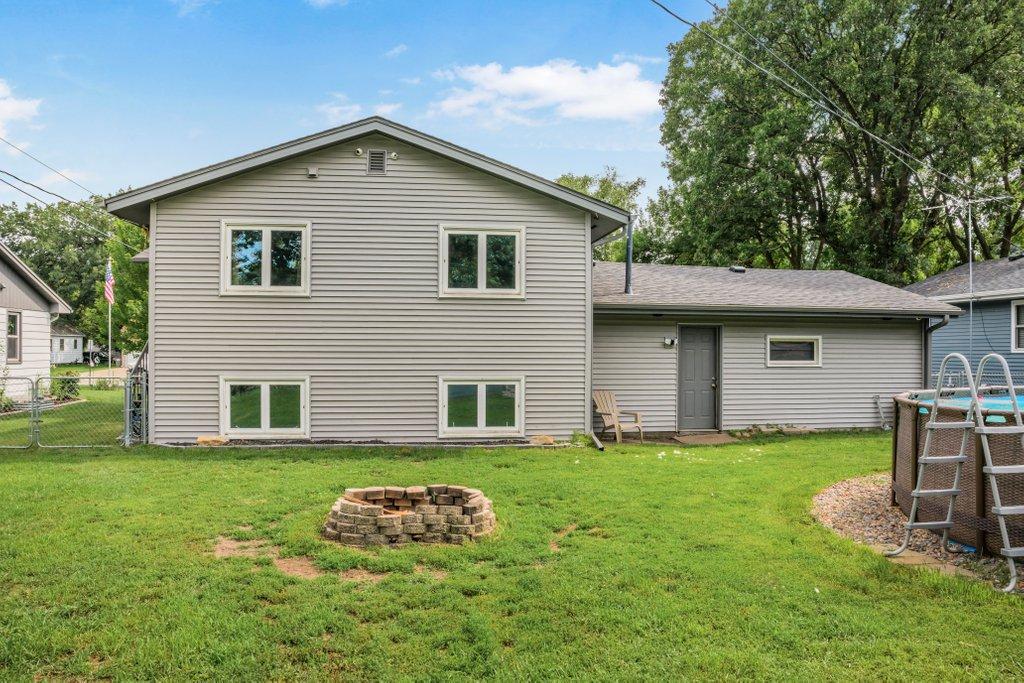 End your day around the fire pit in this spacious backyard featuring a screened porch, above-ground pool, storage shed, and plenty of room to relax, entertain, and make memories.