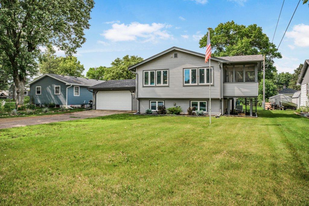 Well-maintained split-entry home featuring a spacious yard, attached two-car garage, screened porch, and room to grow, offering comfort, functionality, and space inside and out.
