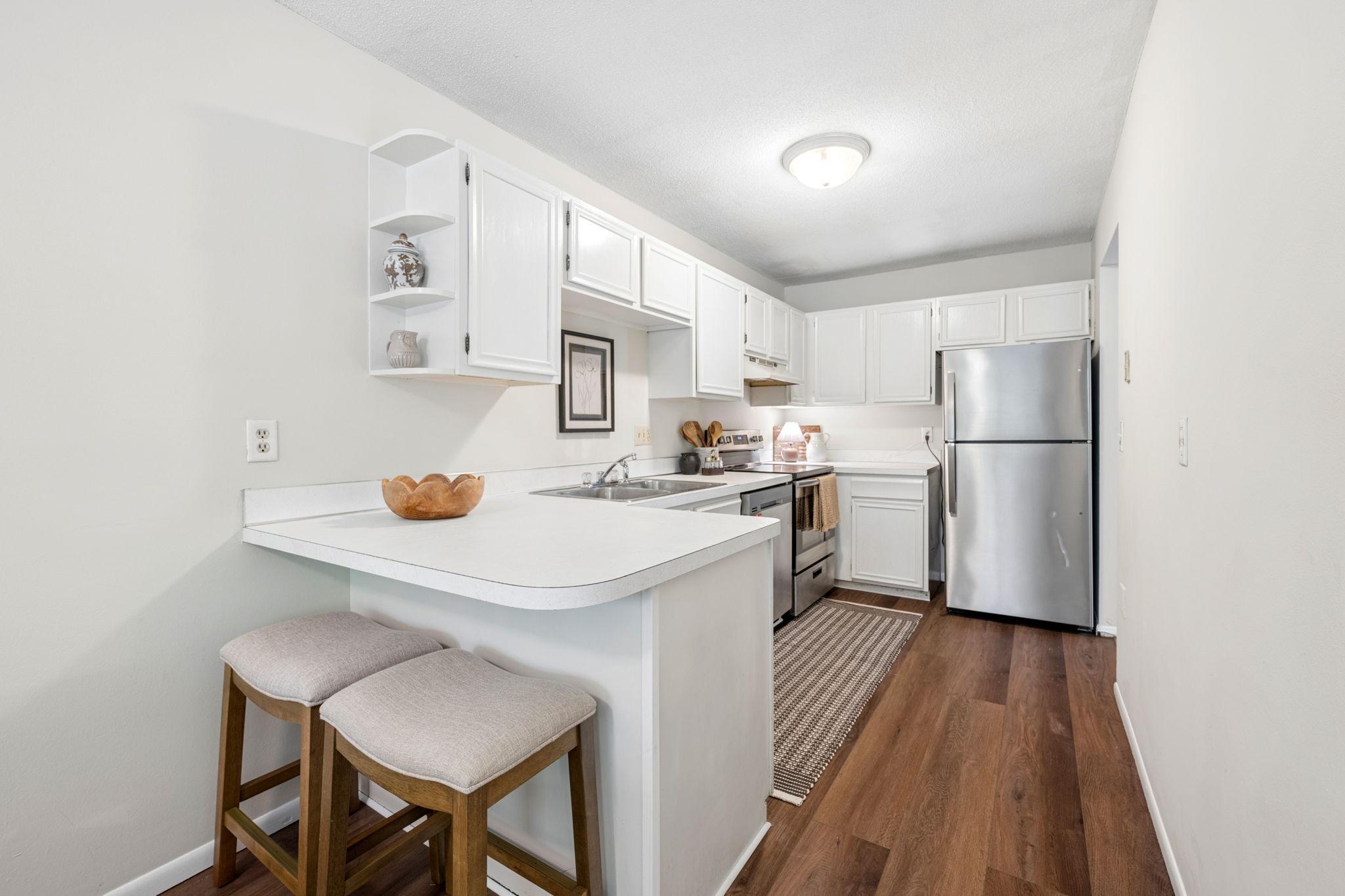 Ample storage space and stainless steel appliances highlight this galley style kitchen.
