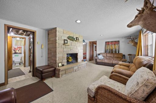 Lower level family room is also centered around the fireplace and offers lake views