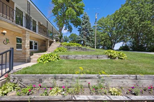 Tiered landscaping adds charm as you walk up to the entry