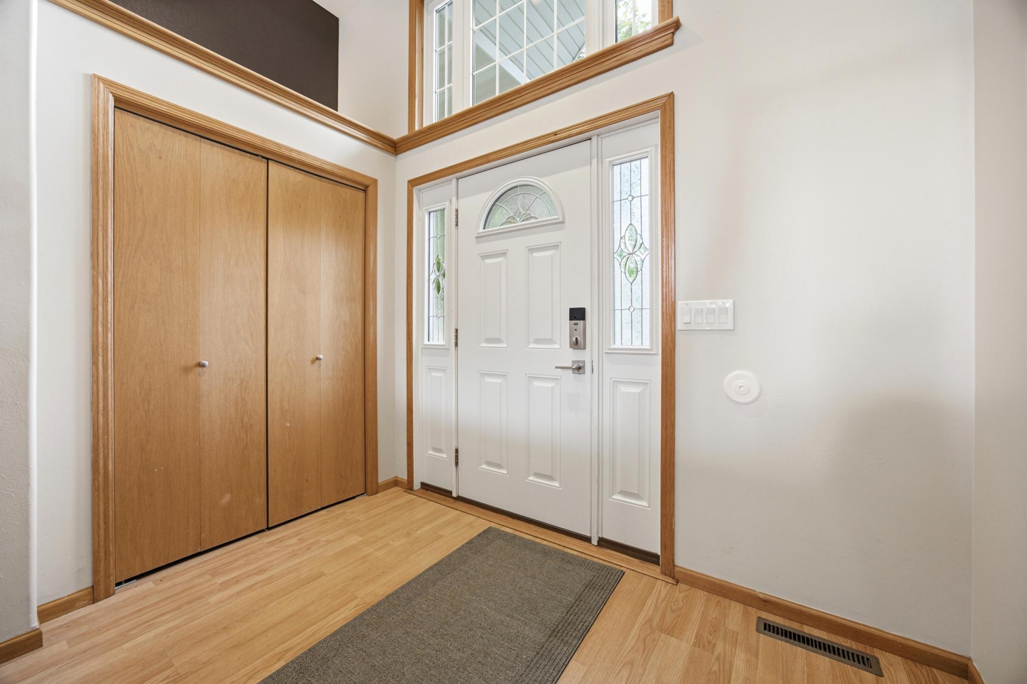 Large, bright foyer with coat closet