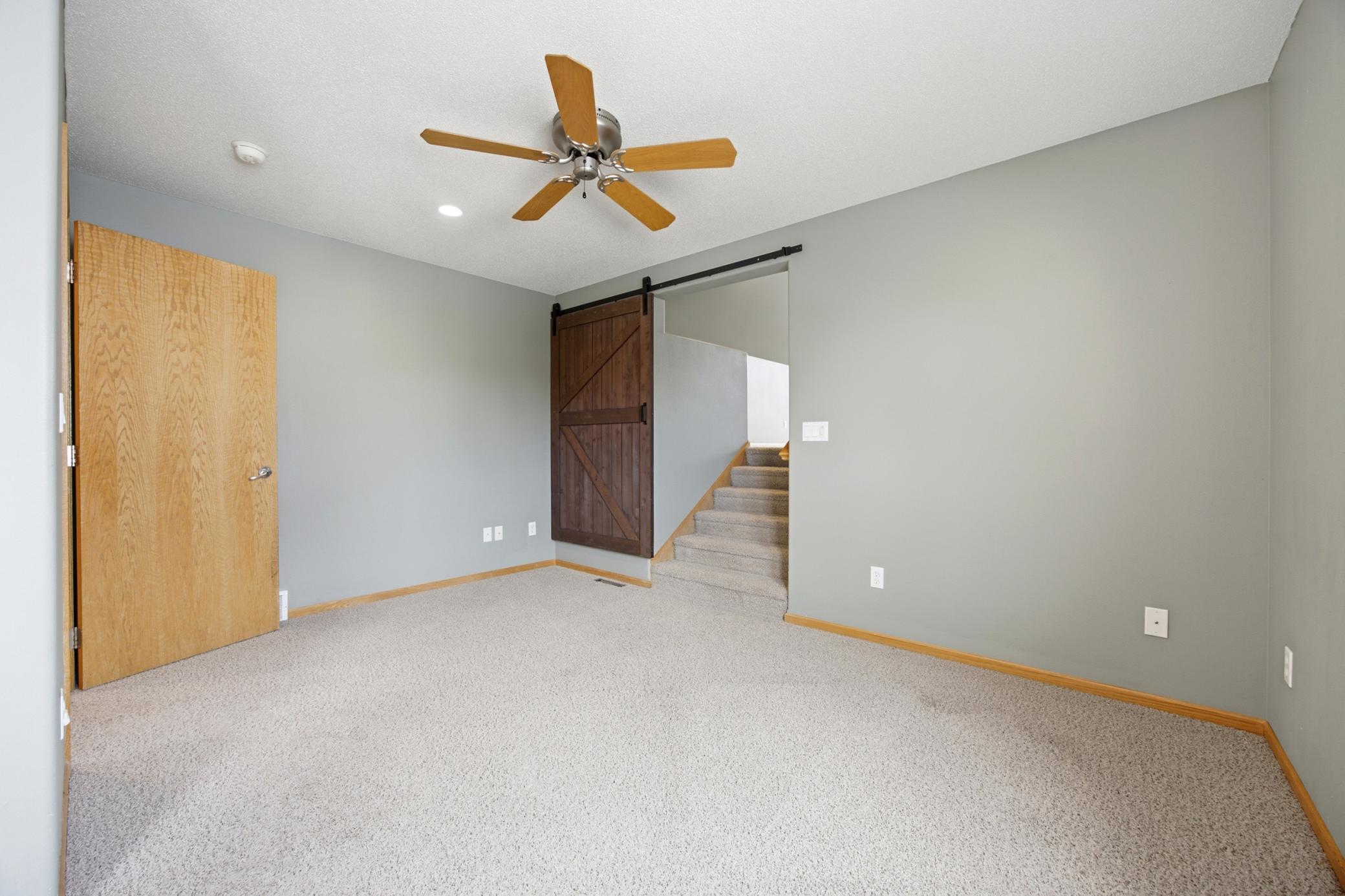 Primary suite stairs up to room over garage