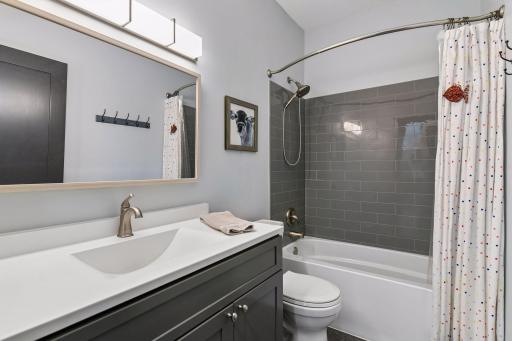 Completely remodeled bathroom on the main level with tiled shower/tub combo