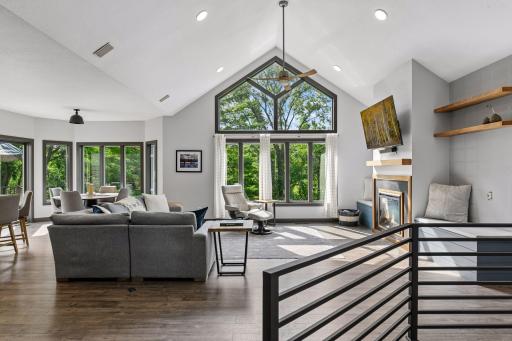 Vaulted great room is the heart of the home with stunning views to private wooded backyard