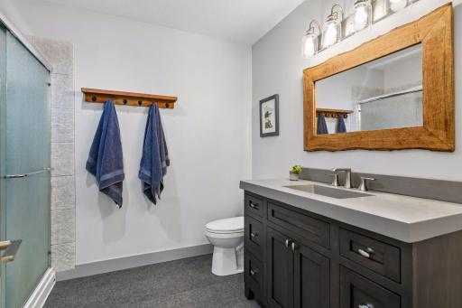 The lower-level bathroom with walk in shower and updated vanity