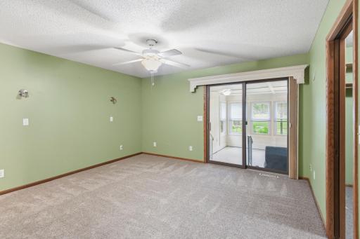 The primary suite with access to porch ~ Bedrooms and family all have new carpet!