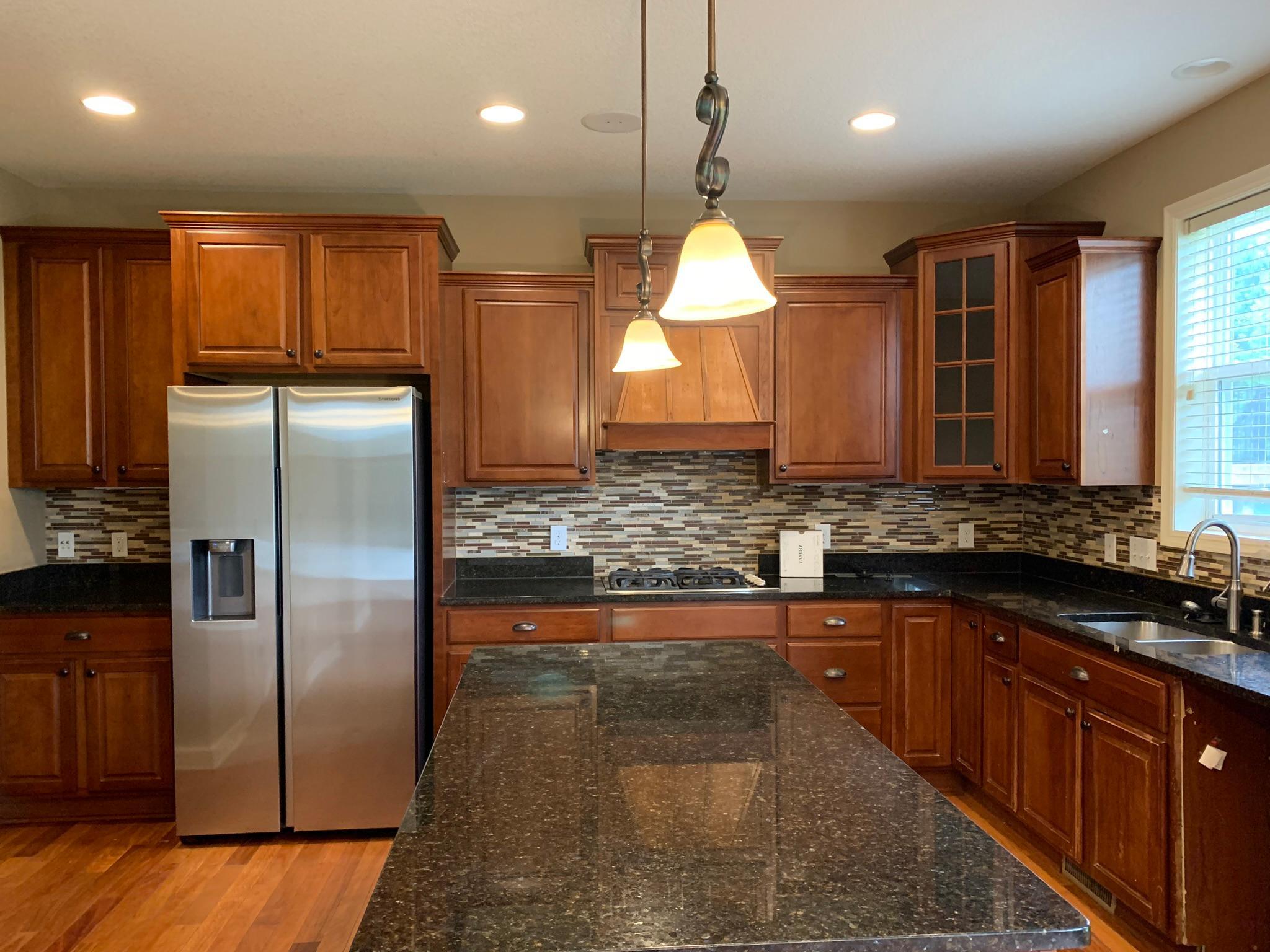 12 - Large center island and kitchen window overlooking backyard.JPEG