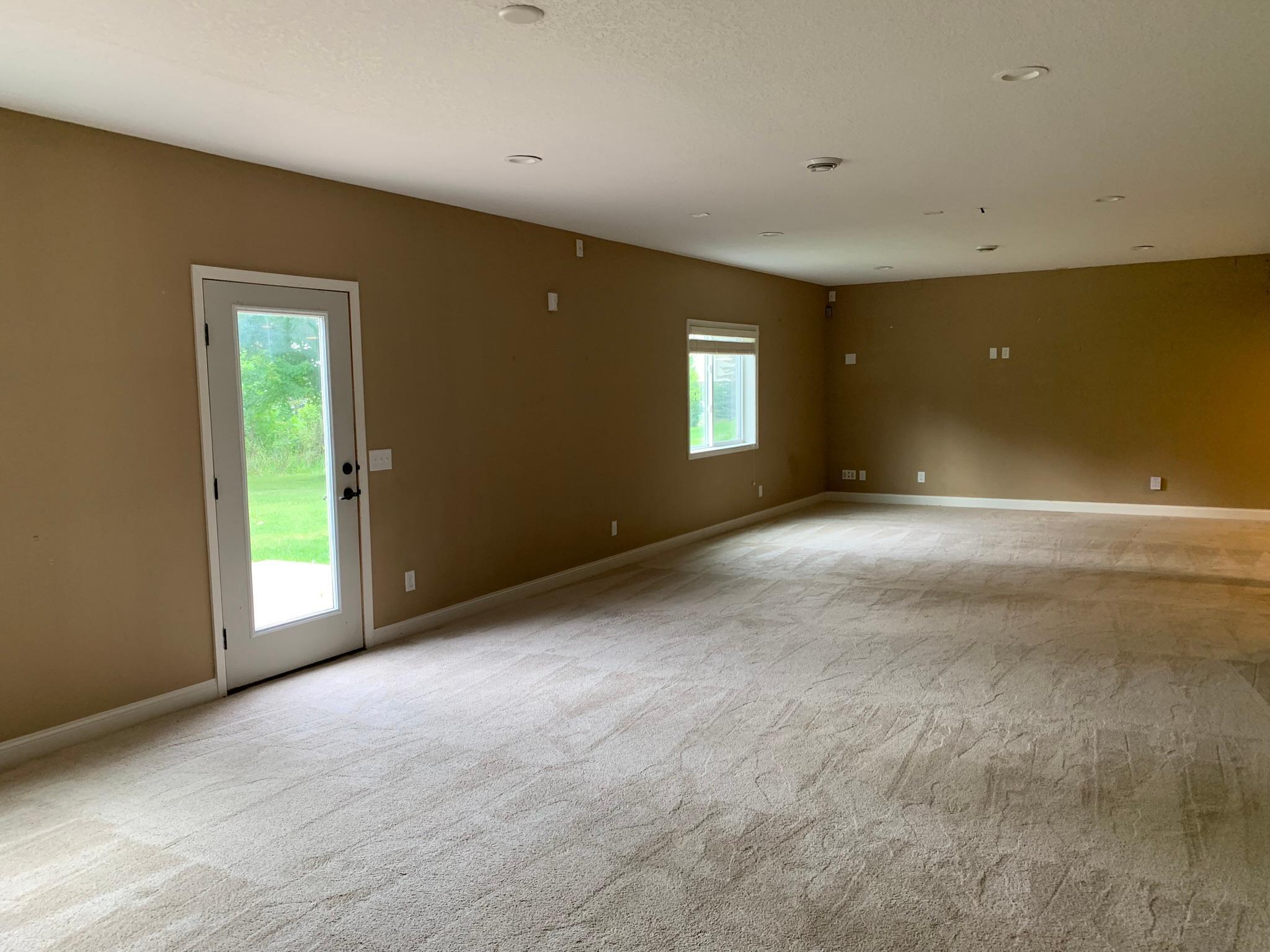 33 - Lower level amusement room with walkout door to backyard.JPEG