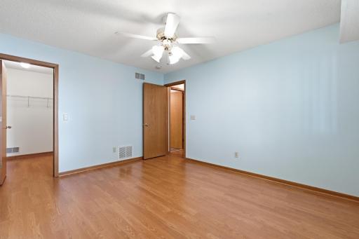 Reverse view of spacious primary bedroom with walk-in closet