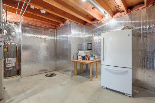 Lower level unfinished storage area with extra refrigerator freezer that could be included if wanted.