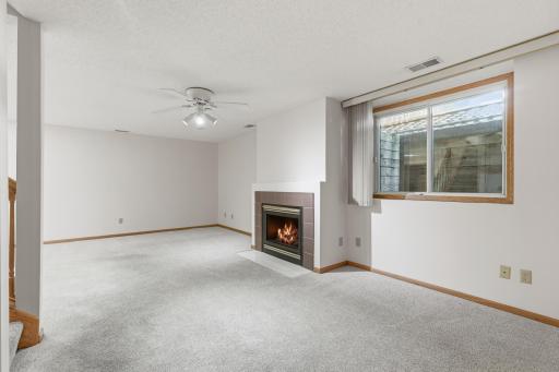 Reverse view of lower level family room and gas burning fireplace