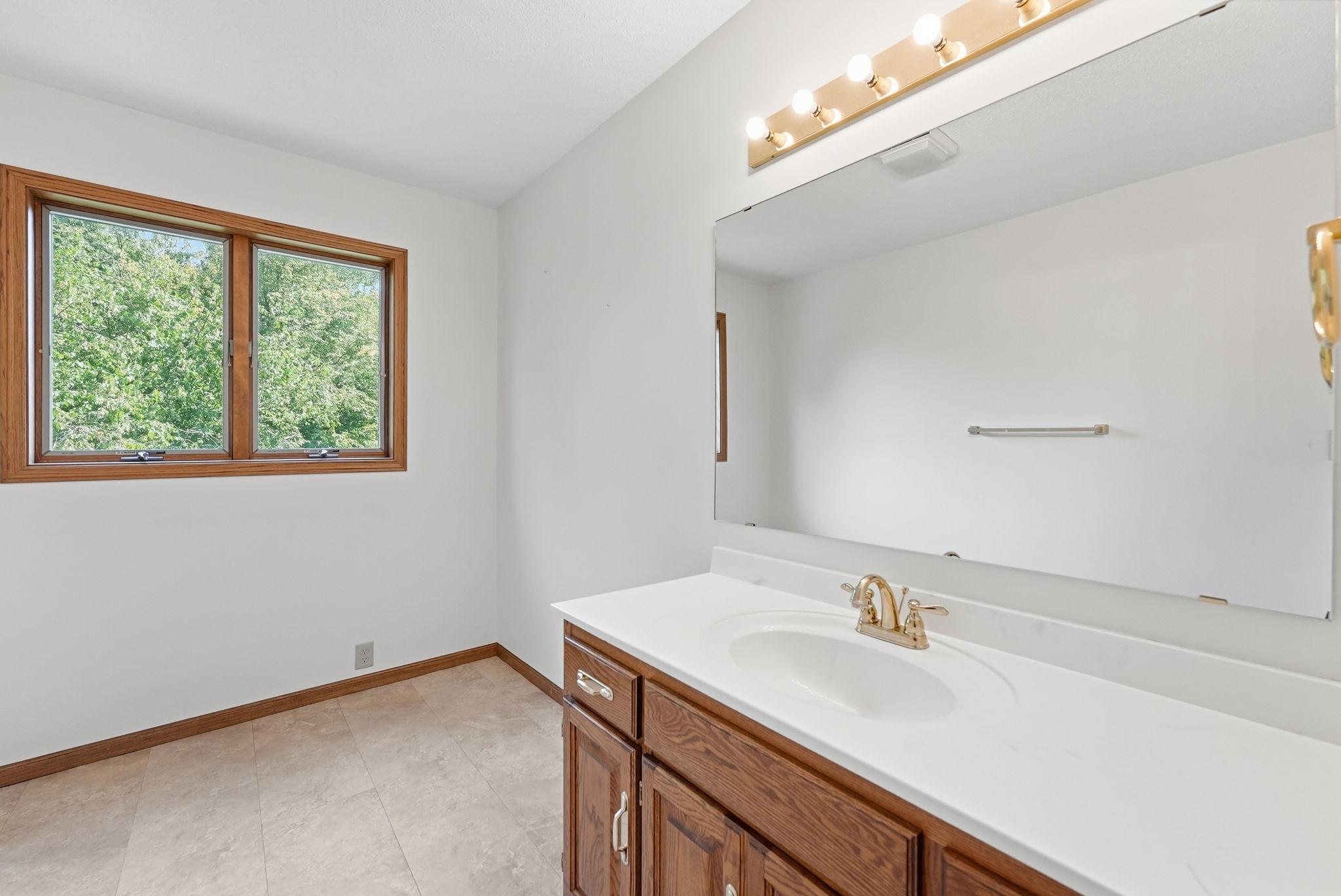 Private primary bathroom with large vanity.