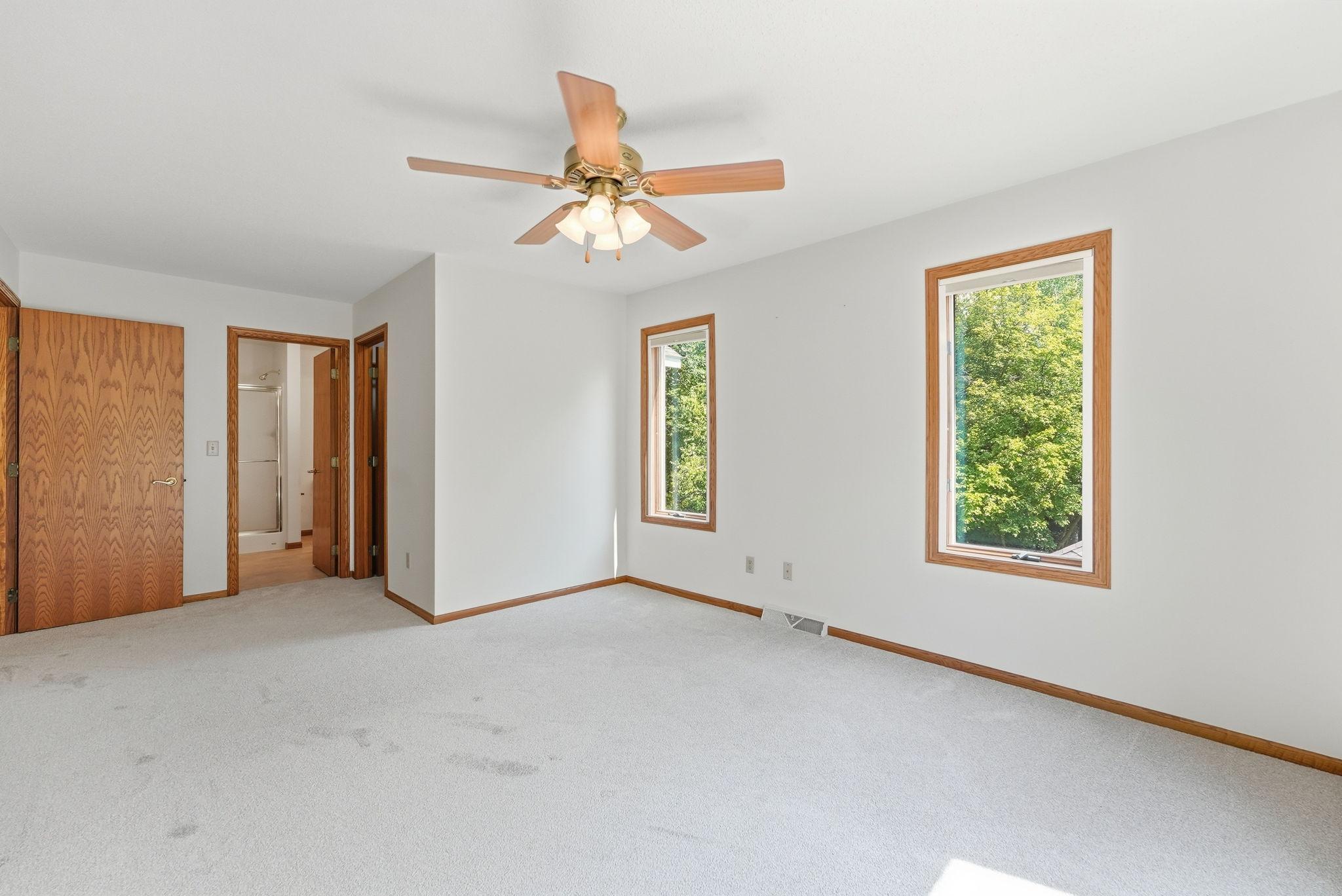 Primary bedroom features a walk in closet and private balcony over looking the back yard.
