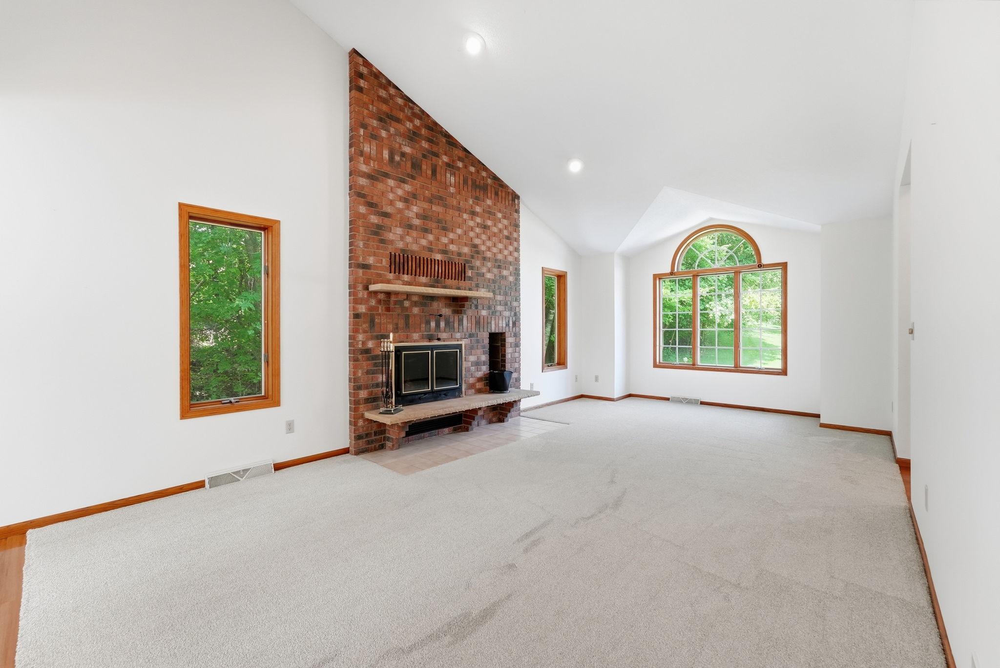 Floor to ceiling bricked in fireplace becomes a focal point. Fireplace was professionally checked in 2026.
