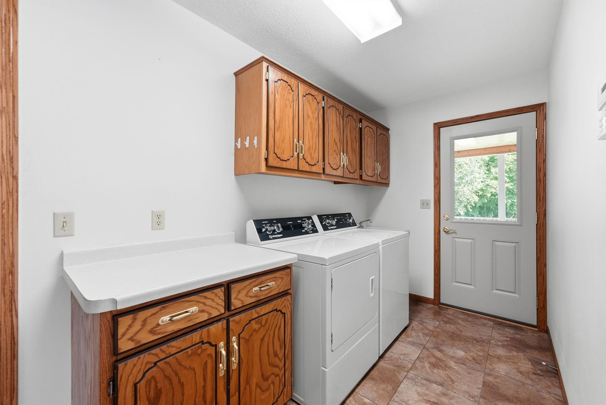 Convenient main level laundry with storage space for necessities, 2019 new washer and dryer.