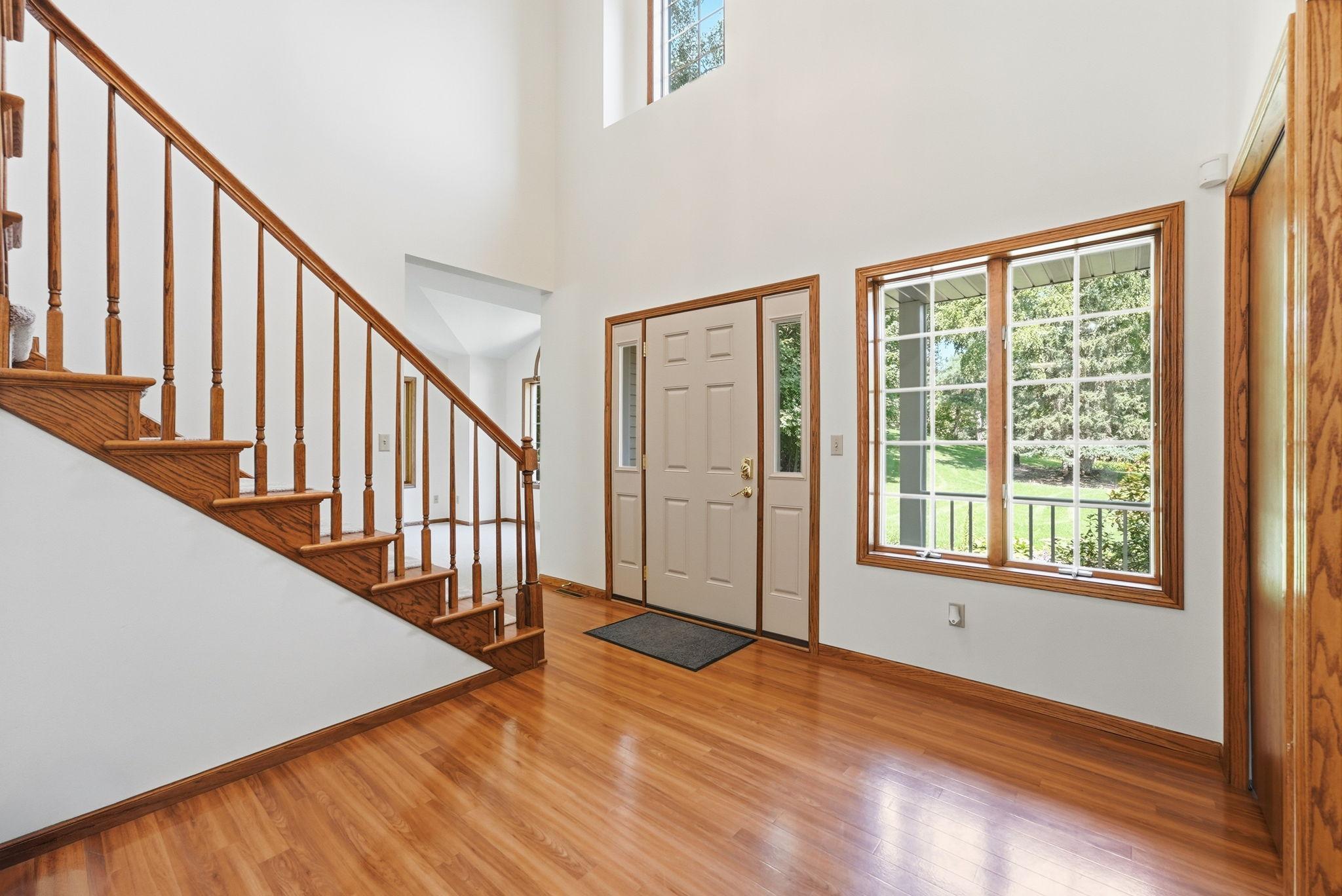 An impressive two-story foyer creates a bright, open, and inviting entrance.