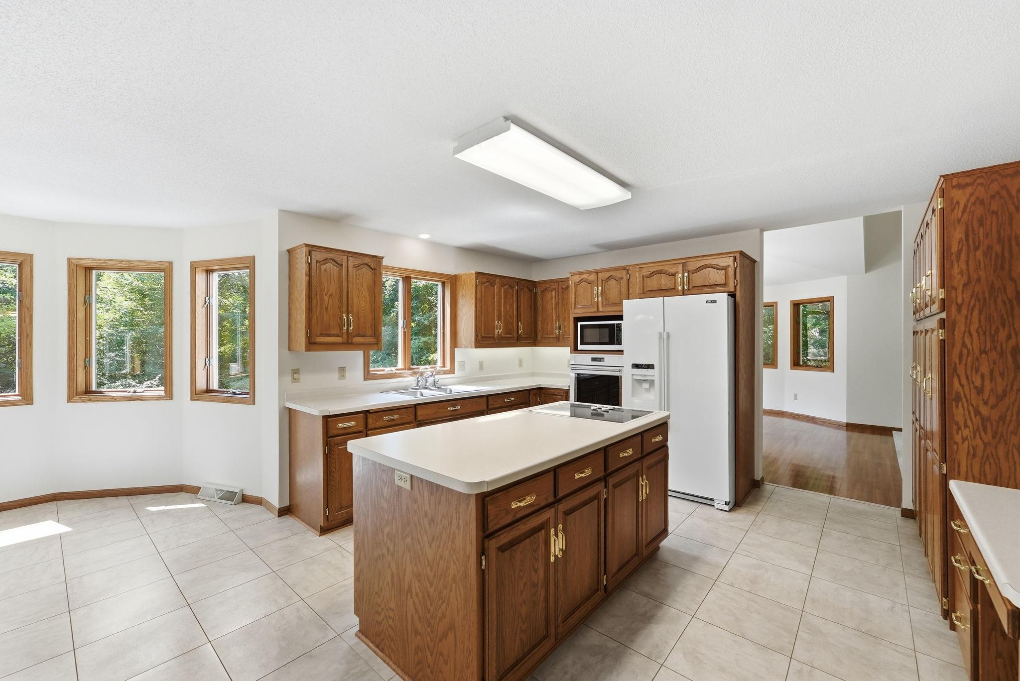 A beautifully appointed kitchen serves as the centerpiece of the home with a new refrigerator and oven replaced in 2019.