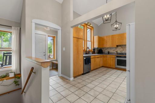 The kitchen is bright and open with vaulted ceilings.