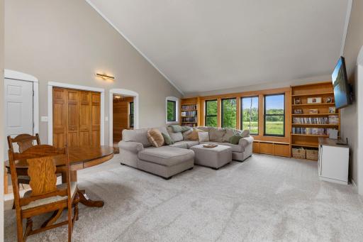 The living room has a full wall of custom built-ins and incredible nature views.