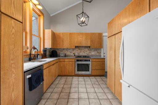 The updated kitchen has ample cabinetry and some stainless appliances.