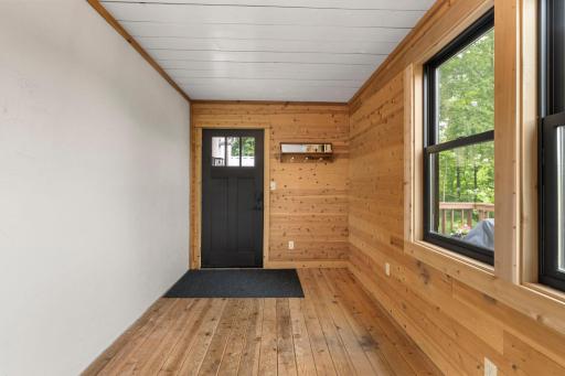 The main level porch leads to the deck and a rear access to the garage.