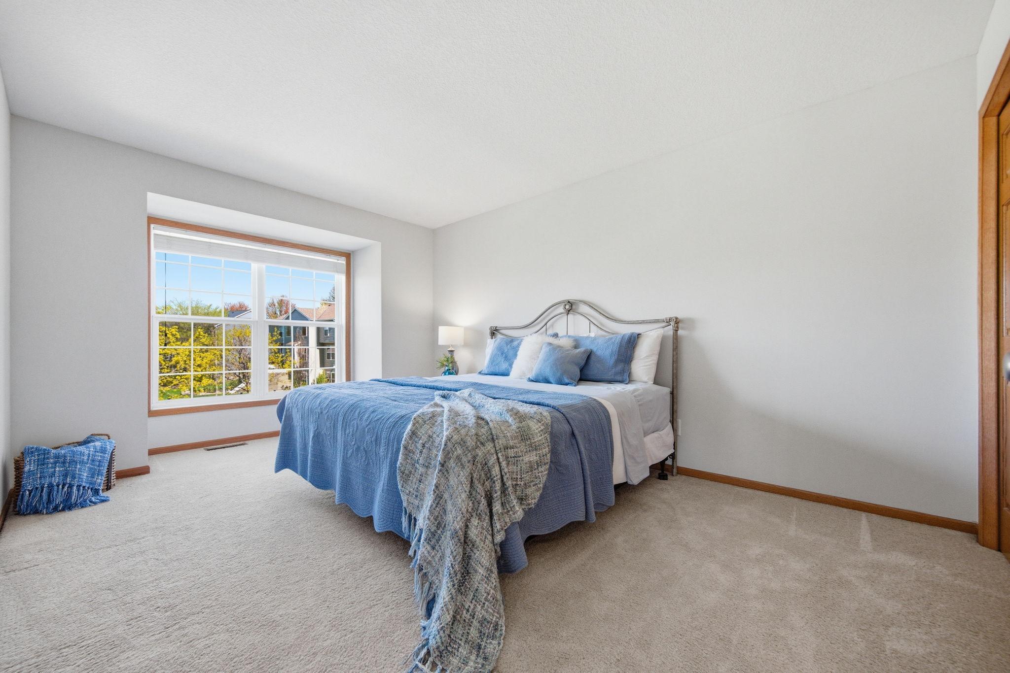 This additional upstairs bedroom is generously sized, featuring ample closet space and abundant natural light. The carpet is also in excellent condition.