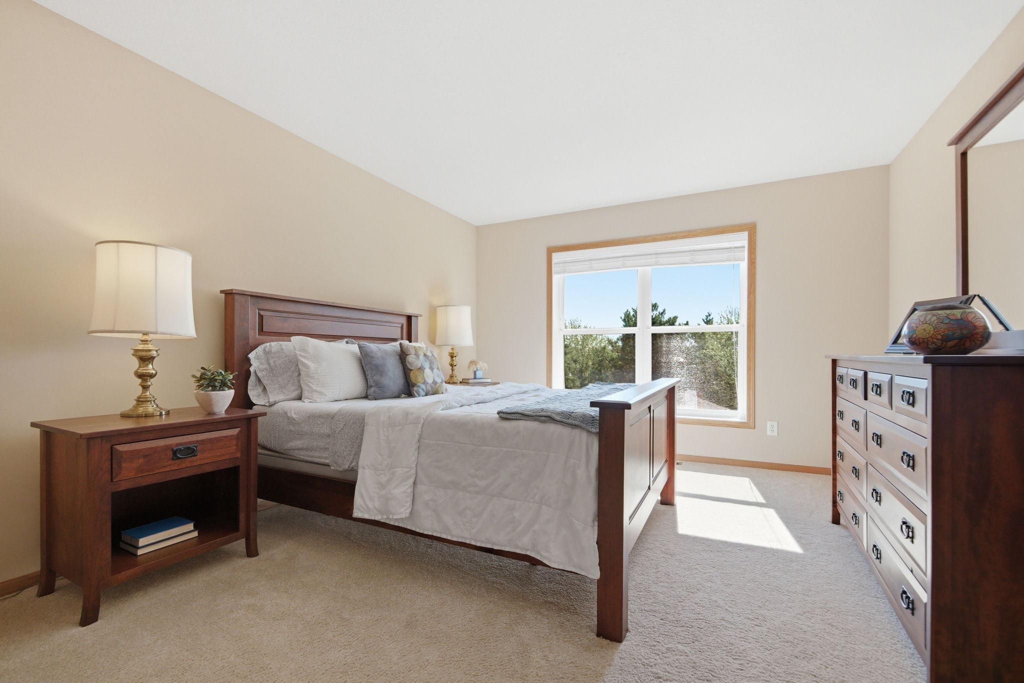 his upstairs bedroom features plush carpeting, abundant natural light, and generous closet space. All of the rooms throughout the home are exceptionally spacious.