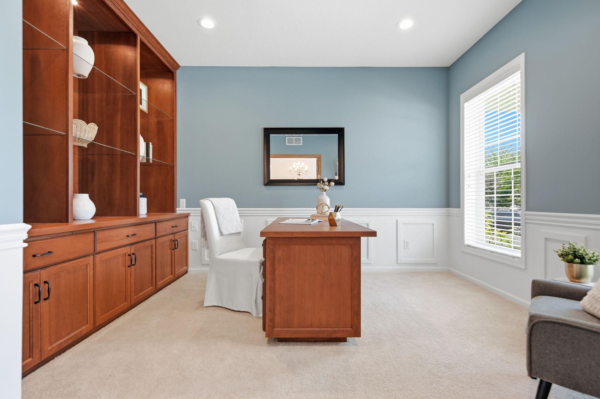 The custom-designed office features a beautifully crafted built-in desk with soft-close drawers, complemented by windows in excellent condition. This refined and functional space is ideal for working from home in comfort and style.