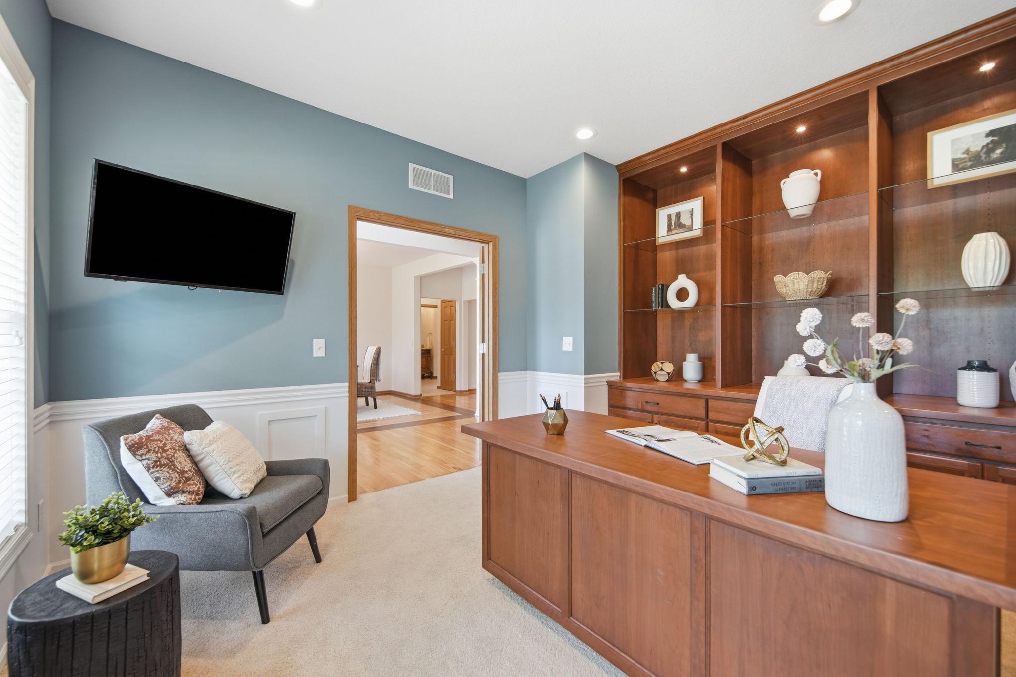 Another view of this beautiful office featuring custom built-ins, soft-close drawers, and French doors for privacy.