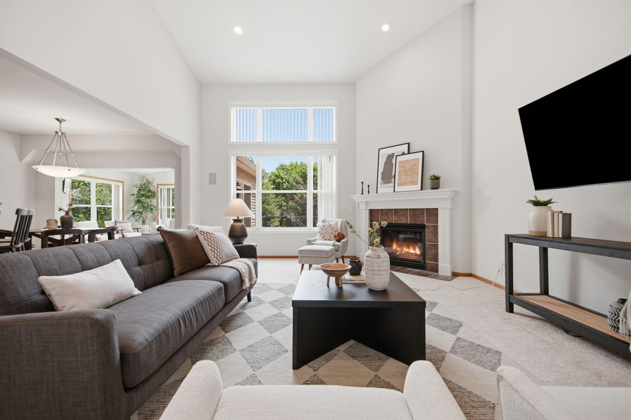 This photo beautifully highlights the spacious living room layout, open flow, and bright, airy feel.