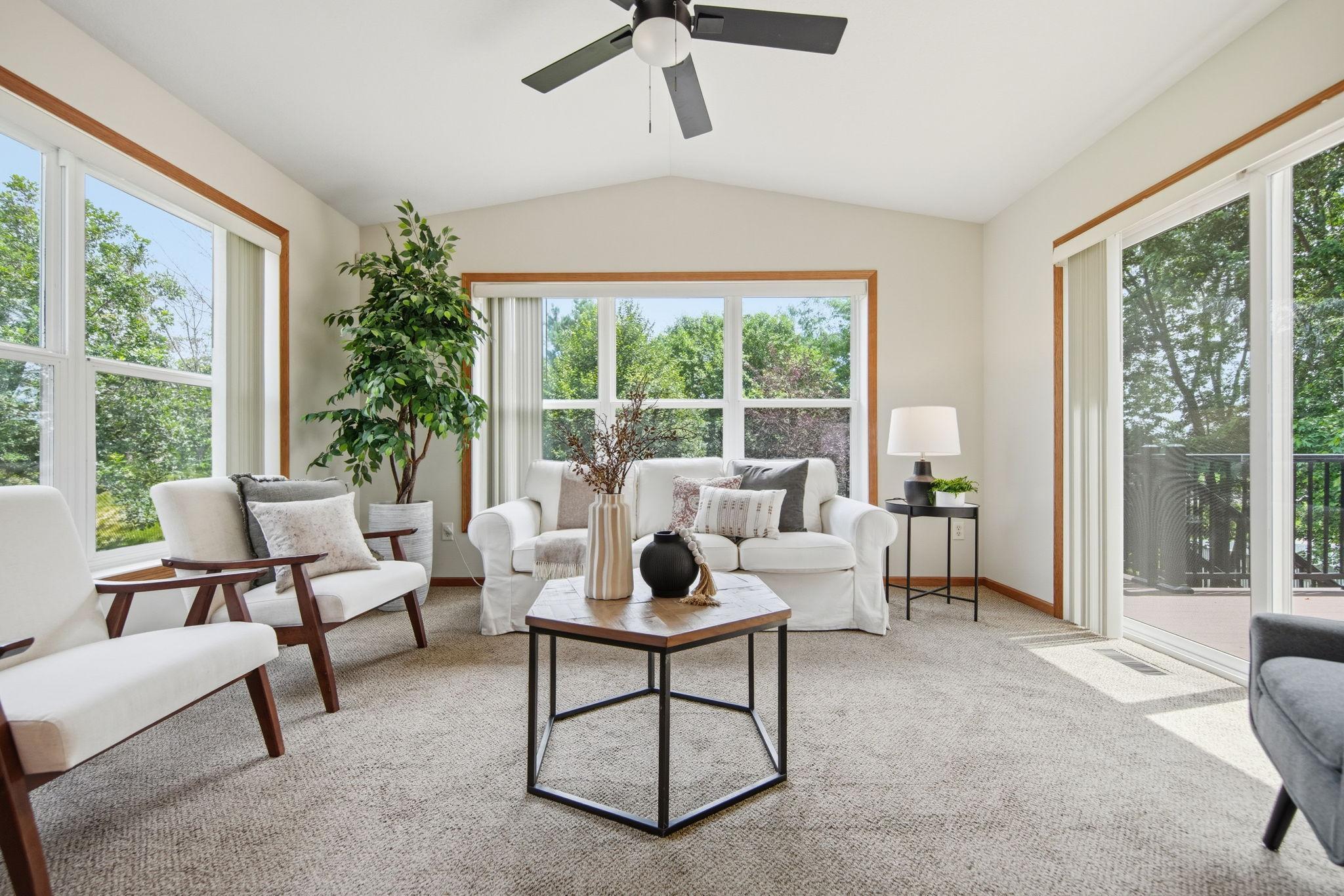 The four-season porch offers a bright and airy retreat with a vaulted ceiling and sliding glass doors that provide seamless access to the newly completed maintenance-free deck