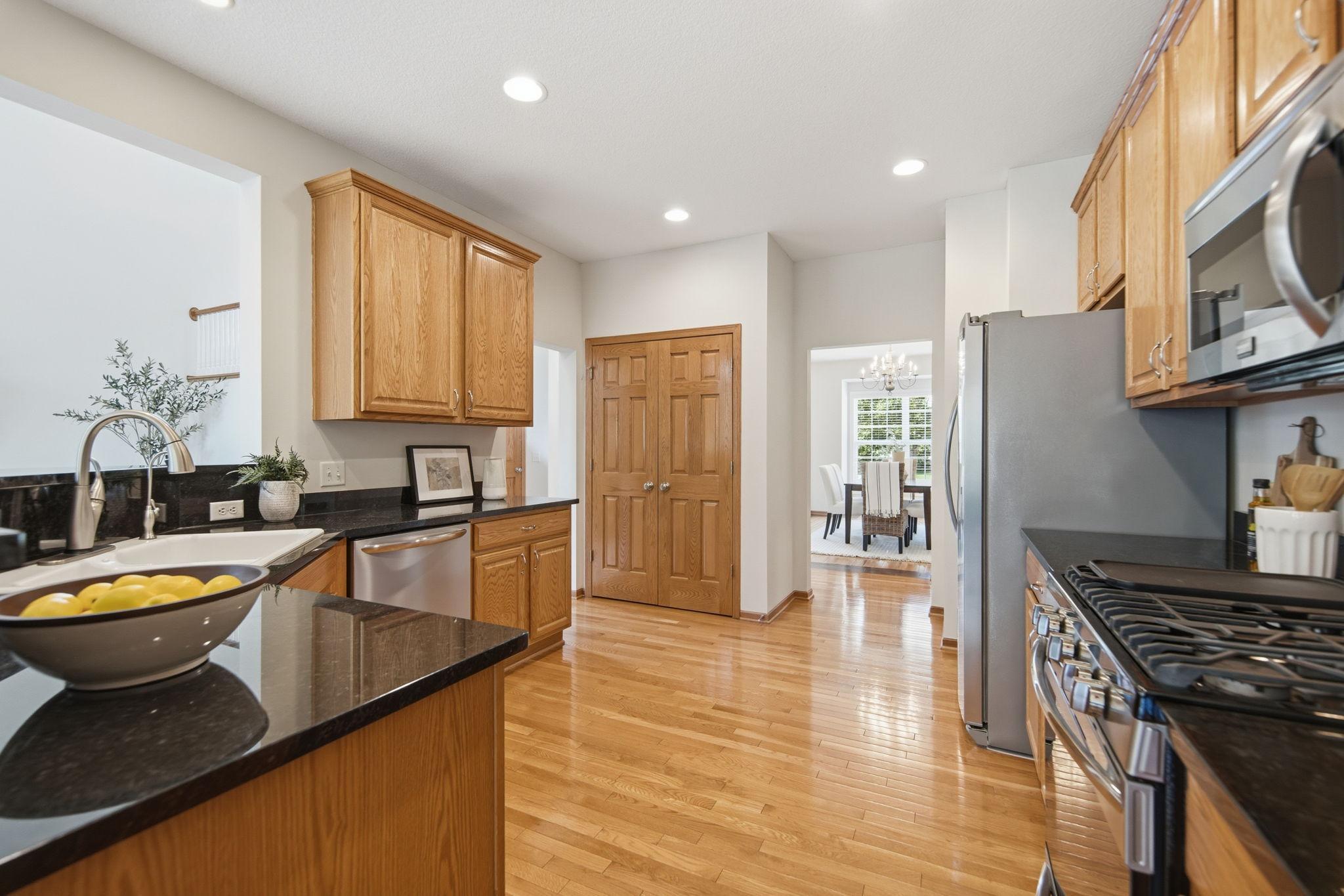 The open kitchen is thoughtfully designed for entertaining, offering generous counter space, extensive cupboard storage, and an impressive amount of storage. The kitchen has newer Stainless Steel appliances, - Stove, Dishwasher and Refrigerator