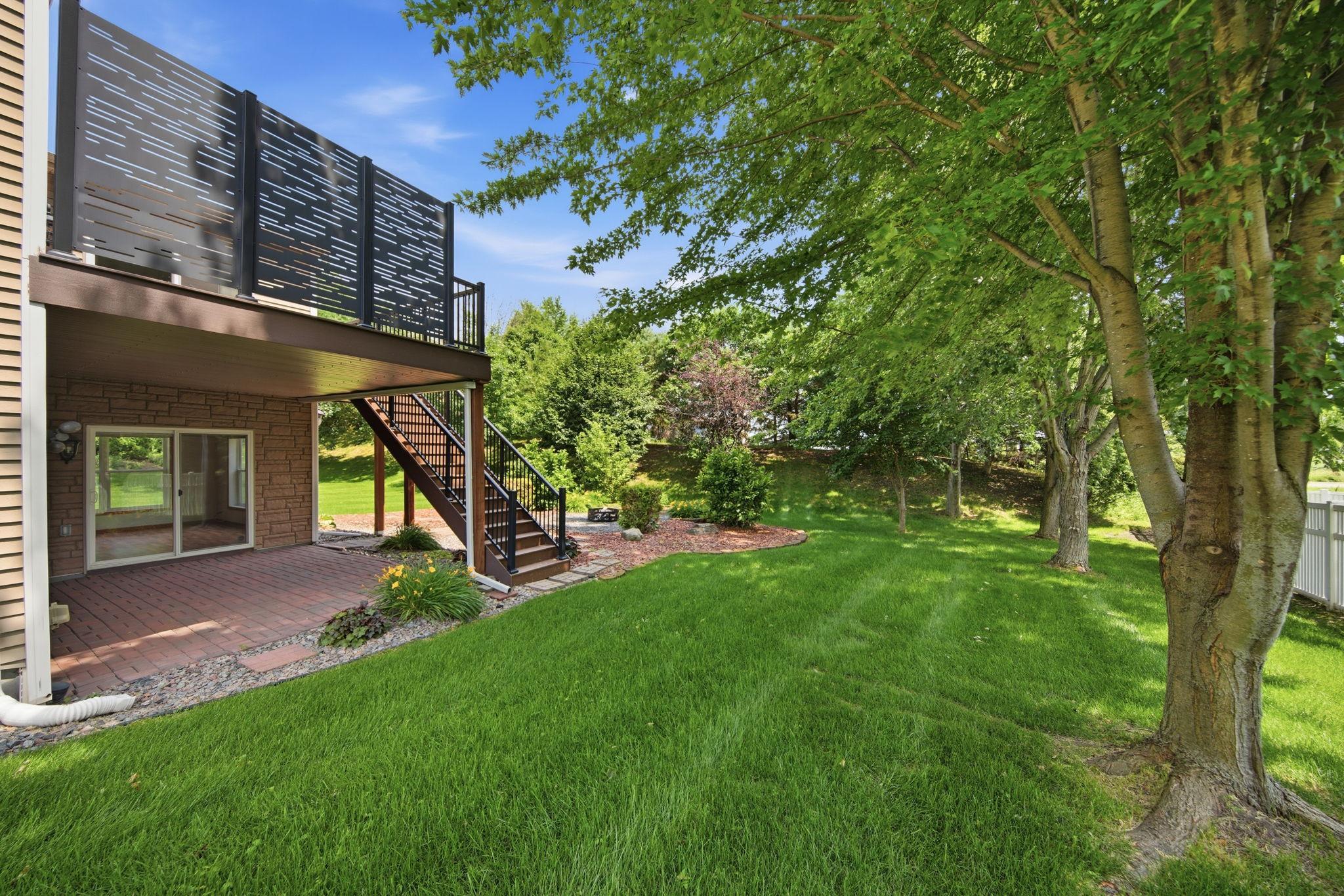 A charming lower-level patio offers a peaceful retreat—perfect for staying cool on warm days or relaxing while watching the rain on a cool summer afternoon.