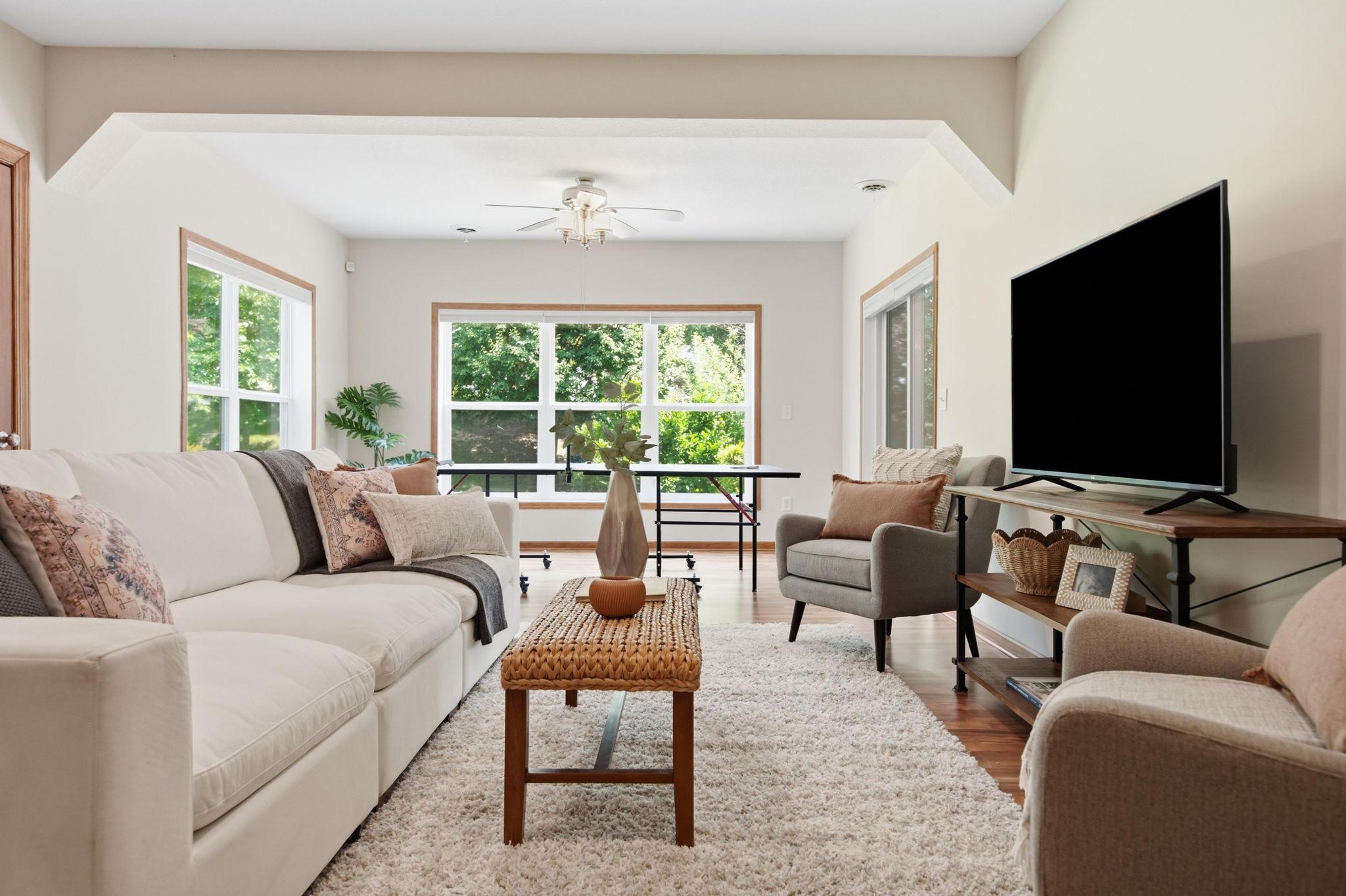 The LL living/family room is thoughtfully designed with upper display cubbies for treasured items and concealed storage behind the two lower doors. walks out to a private patio and is enhanced by oversized daylight windows and the Lower Level Walkout
