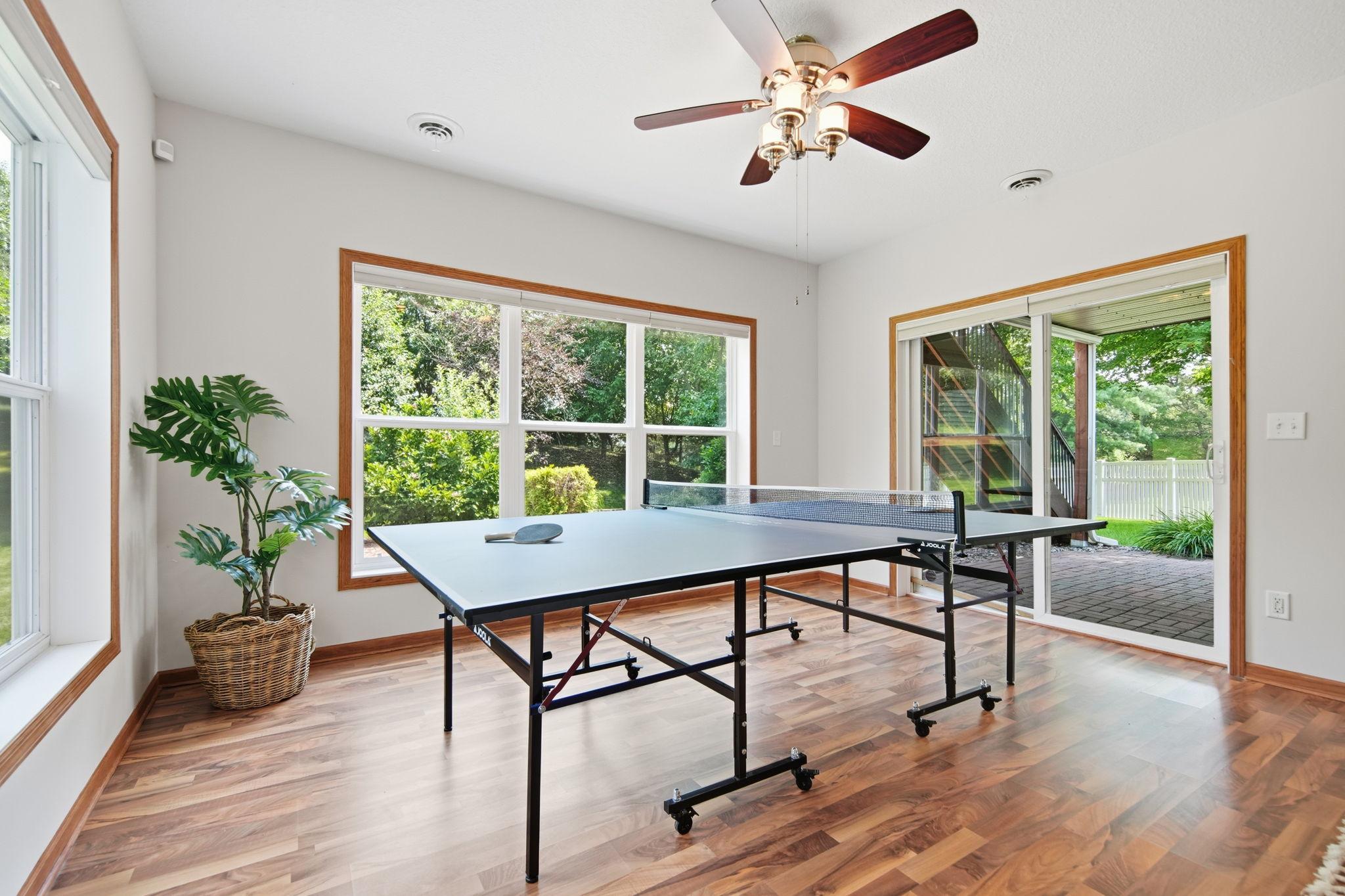 Another view of the ping pong table just steps out the backyard to the covered porch and fire pit area.