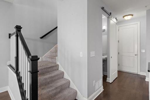 Upgraded bannister and sliding door for 1/4 bathroom. Door on right leads to garage.