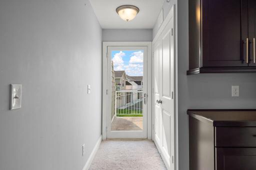 Glass door leads to deck, white doors lead to the laundry closet, and notice nice cabinetry for all the extra stuff!