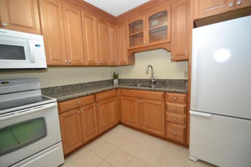 An Abundance of Maple Cabinets with lighted glass facings