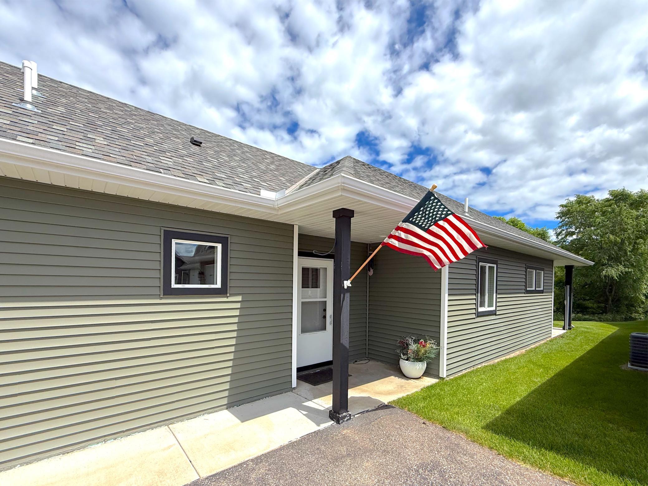 Covered front porch with room for flower pots, chair or a bench to greet to your guests.