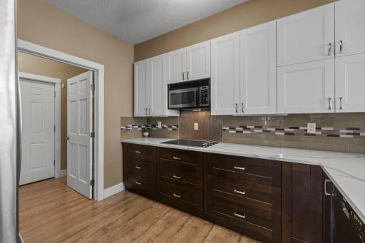 A stylish backsplash separates the two-tone cabinets