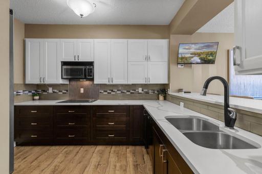 The kitchen is connected to the living / dining space with an elevated breakfast bar for additional dining