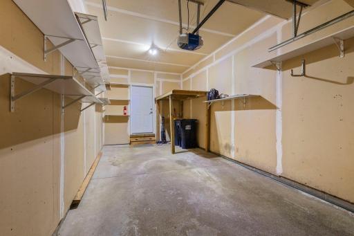 There is a lofted storage space and wall shelves for storage