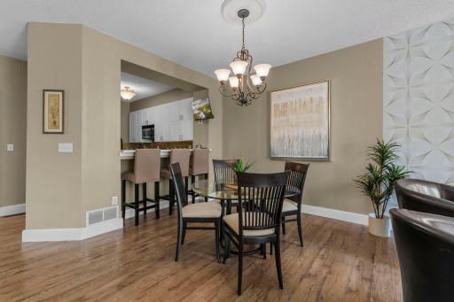 The dining area is adjacent to the breakfast bar and open to the kitchen
