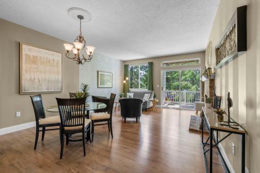 The living and dining room is flooded with light from the west-facing window and door